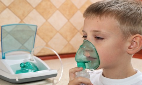 Child using an inhealer during an Asthma attck Child using an inhealer during an Asthma attck